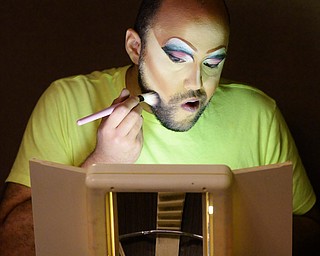 Jeff Lange | The Vindicator FRI, MAY 6, 2016 - Grayson McCaleb of Conneaut applies makeup to his face prior to the start of Friday night's Pride Pageant held at YSU.