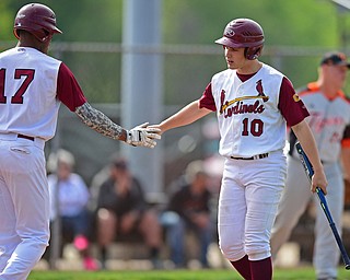 STRUTHERS, OHIO - MAY 10: 2016: Dom Pecchia #10 of Mooney is congratulated by teammate Aaron Woodberry #17 of Mooney after scoring the first Mooney run in the second inning of Tuesday afternoons game at Cene Park. Mooney won 6-3. DAVID DERMER | THE VINDICATOR