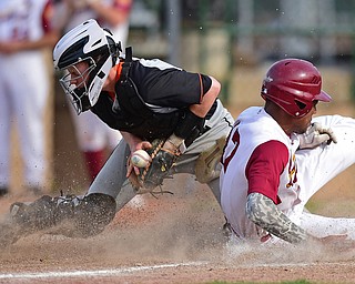 STRUTHERS, OHIO - MAY 10: 2016: Aaron Woodberry #17 of Mooney slides into catcher John Ritter #14 of Springfield knocking the ball free and allowing the run to score in the fourth inning of Tuesday afternoons game at Cene Park. Mooney won 6-3. DAVID DERMER | THE VINDICATOR