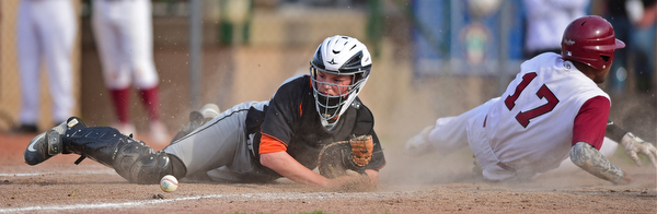 STRUTHERS, OHIO - MAY 10: 2016: Catcher John Ritter #14 of Springfield crawls for the baseball after Aaron Woodberry #17 of Mooney slid into him knocking the ball free and allowing a run to score in the fourth inning of Tuesday afternoons game at Cene Park. Mooney won 6-3. DAVID DERMER | THE VINDICATOR