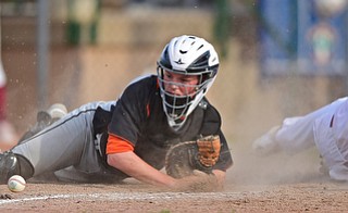 STRUTHERS, OHIO - MAY 10: 2016: Catcher John Ritter #14 of Springfield crawls for the baseball after Aaron Woodberry #17 of Mooney slid into him knocking the ball free and allowing a run to score in the fourth inning of Tuesday afternoons game at Cene Park. Mooney won 6-3. DAVID DERMER | THE VINDICATOR