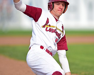 STRUTHERS, OHIO - MAY 10: 2016: Mike Williams #5 of Mooney slides into third base after a misplayed ball at home plate allowed him to advance in the fourth inning of Tuesday afternoons game at Cene Park. Mooney won 6-3. DAVID DERMER | THE VINDICATOR