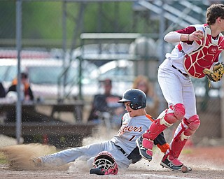 STRUTHERS, OHIO - MAY 10: 2016: Catcher Dean Lauer #21 of Mooney forces out Jarrett Orbin #1 of Springfield at home plate in the fifth inning of Tuesday afternoons game at Cene Park. Mooney won 6-3. DAVID DERMER | THE VINDICATOR