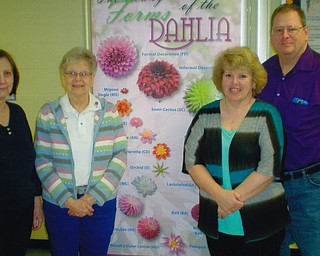 SPECIAL TO THE VINDICATOR
The Mahoning Valley Dahlia Society officers from left, Joyce Habeger secretary; Harriet Chandler, president; Becky Schmitt, treasurer; and Bob Schmitt, vice president, are preparing for the society’s annual plant sale. Dahlias, ready to plant, will be available from 1 to 5 p.m. Sunday at Calvary Baptist Church, 1463 Shields Road, Boardman.