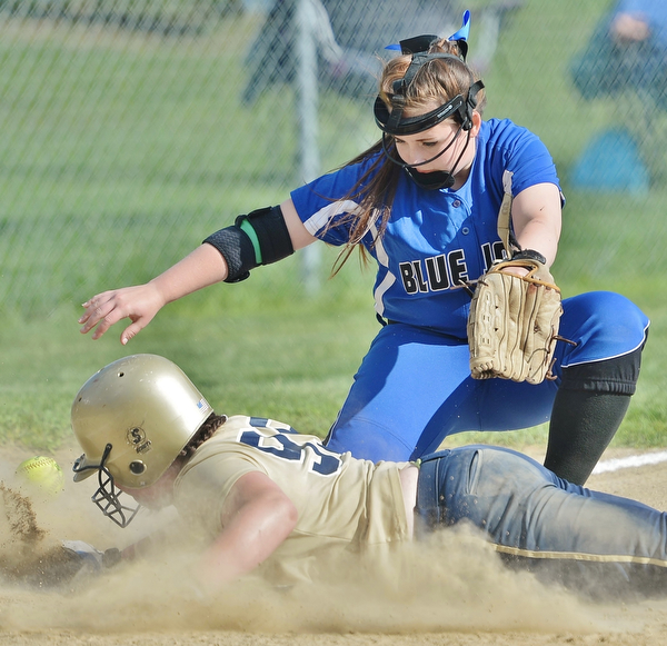 Jeff Lange | The Vindicator  FRI, MAY 13, 2016 - Jackson-Milton third baseman Brooklyn Gallant misses the throw from home as Lowellville's Olivia Sotlar dives safely into the bag in the second inning of Friday's game at Jackson-Milton High School.