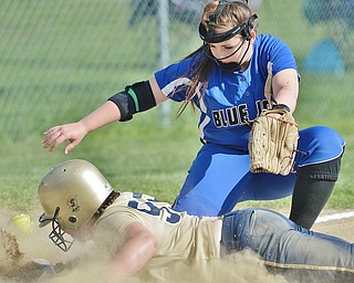 Jeff Lange | The Vindicator  FRI, MAY 13, 2016 - Jackson-Milton third baseman Brooklyn Gallant misses the throw from home as Lowellville's Olivia Sotlar dives safely into the bag in the second inning of Friday's game at Jackson-Milton High School.