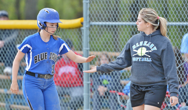 Jeff Lange | The Vindicator  FRI, MAY 13, 2016 - Jackson-Milton's Jordon Stratton (3) is congratulated by first base coach Tricia Bettura after hitting at single in the fifth inning of Friday's game against Lowellville at Jackson-Milton High School.