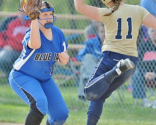 Jeff Lange | The Vindicator  FRI, MAY 13, 2016 - Blue Jays' first baseman Madde Hyland (left) makes a play at first as Lowellville's Jessica Johnston (11) steps on the bag in the sixth inning of Friday's game at Jackson-Milton High School.