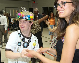 William D. Lewis The Vindicator Purple Cat client Eric Trebus of Canfield dances with Hailey Boyer, a student at St. Nick's School in Struthers during Purple Cat Prom held at St. Nick's Hall in Struthers 5-14-16. Studnets from St Nick's helped out at the event.