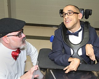 William D. Lewis The Vindicator Purple Cat director Jimmy Sutman talks with client Axel Rivera of Youngstown during Purple Cat Prom held at St. Nick's Hall in Struthers 5-14-16.