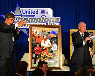 YOUNGSTOWN, OHIO - MAY 16, 2016: Ed Muransky (left) and United Way of Youngstown President Bob Hannon auction off a Stoops family painting Monday evening during the Champions Among Us Banquet at the Lake Club. DAVID DERMER | THE VINDICATOR