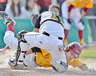 Jeff Lange | The Vindicator  MON, MAY 16, 2016 - Crestview catcher Jacob Wick (10) tags out Mooney's Chris Lewis (11) at the plate to end the top of the fifth inning of Monday's district semifinal at Cene Park.