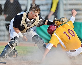 Jeff Lange | The Vindicator  MON, MAY 16, 2016 - Mooney baserunner Dom Pecchia (10) slides safely to home plate under the tag of Crestview catcher Jacob Wick (left) in the seventh inning of Monday's game at Cene Park.