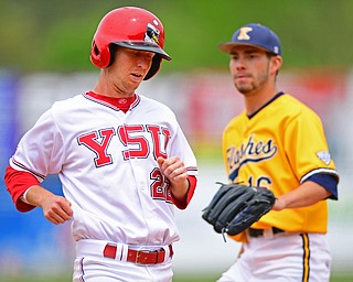 NILES, OHIO - MAY 17, 2016: Jonny Miller #22 of YSU scores a run after a pass ball from Eli Martin #16 of Kent State in the sixth inning of Tuesday afternoons game at Eastwood Field. YSU won 11-10 in eleven innings. DAVID DERMER | THE VINDICATOR