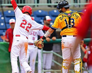 NILES, OHIO - MAY 17, 2016: Jonny Miller #22 of YSUcelebrates after scoring the game winning run beating a late tag from Tim DalPorto #13 of Kent State in the eleventh inning of Tuesday afternoons game at Eastwood Field. YSU won 11-10 in eleven innings. DAVID DERMER | THE VINDICATOR