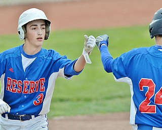 Jeff Lange | The Vindicator  TUE, MAY 17, 2016 - Reserve's Ryan Demsky (3) fist bumps teammate Dom Velasquez after scoring a run in the first inning of Tuesday's DIV district semifinal at Bob Cene Park in Struthers.