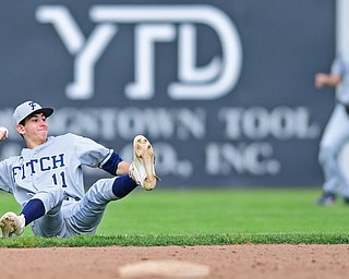 STRUTHERS, OHIO - MAY 18, 2016: Second basemen Jake Gherardi #11 of Fitch attempts to make a throw from his backside after slipping on the grass in the fifth inning of Wednesday nights game at Cene Park. Walsh Jesuit won 2-1. DAVID DERMER | THE VINDICATOR