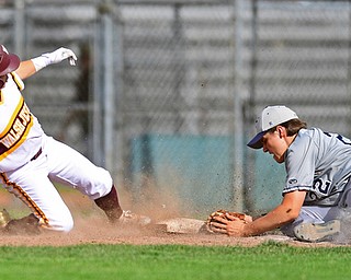 STRUTHERS, OHIO - MAY 18, 2016: First basemen Robbie Russo #22 of Fitch dives to tag the base to force out base runner Bryce Marshall #1 of Walsh Jesuit and turn a double play in the fifth inning of Wednesday nights game at Cene Park. Walsh Jesuit won 2-1. DAVID DERMER | THE VINDICATOR
