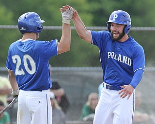 William d Lewis The Vindicator Poalnd's Anthony Calcagni(4) gets congrats from Tony Chairo (20) after scoring 1rst run of win over Ursuline at Cene 5-19-16.