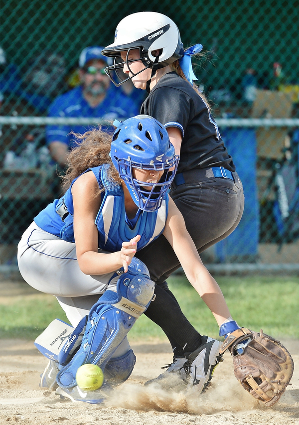 Jeff Lange | The Vindicator  THU, MAY 19, 2016 - Avrey Steiner of Lakeview (top) collides with Hubbard catcher Athena Smith as she scores the game-winning run for the Bulldogs in the bottom of the seventh inning of their Division II district championship game at Alliance High School. Lakeview won 4-3.