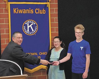 SPECIAL TO THE VINDICATOR | The Kiwanis Club of Youngstown recently honored the grand champion and runner-up from the 83rd annual Vindicator Regional Spelling Bee that took place March 12. Club President Anthony D’Apolito, above, left, presented Barnes & Noble gift cards to runner-up Nina Dill, center, of the Montessori School, and grand champion Ryan Staton from Jackson-Milton. Ryan will represent the Valley at the Scripps National Spelling Bee in Washington, D.C., from Sunday through Friday.
