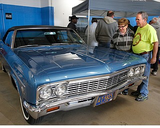   ROBERT K YOSAY | THE VINDICATOR..The First years production a 66 Chevy Convertible .. as David and Sheriann (ok) Griffith from liberty... look at the Impala..The General Motors Company and UAW Local 1112 will host a 50th Anniversary Open House event at Lordstown Complex East Friday, May 20, 2016 from 9 a.m. to 7 p.m. The open house will provide the opportunity to learn more about Lordstown UAW-GM people, modern day vehicle manufacturing, the All-New Chevrolet Cruze and LordstownÕs rich history in the Mahoning Valley.....--30-