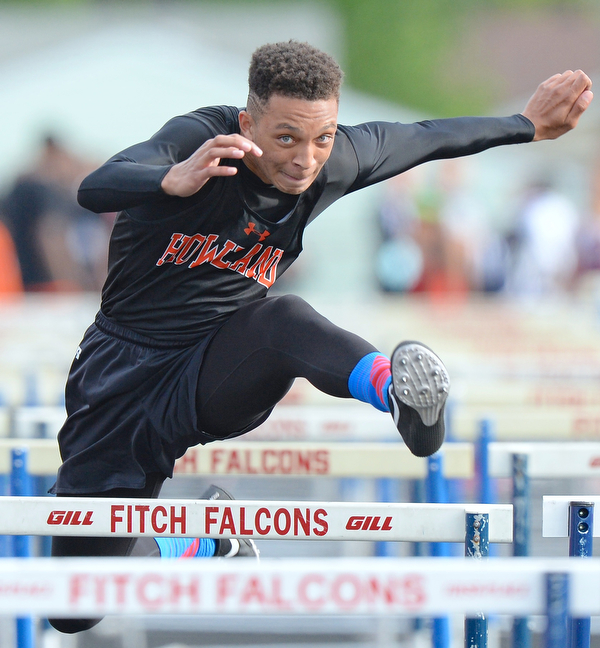 Jeff Lange | The Vindicator  FRI, MAY 20, 2016 - Howland's Jacob Williams clears a hurdle in the boys 110 meter hurdles event during Friday's Division district track meet at Fitch High School.
