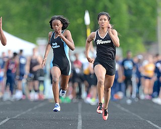 Jeff Lange | The Vindicator  FRI, MAY 20, 2016 - Warren Harding's Justice Richardson (right center) leads (from left) Alliance's Daijana Johnson, East's Jahniya Bowers and Solon's Allison Vason in the girls 100 meter dash during Friday's Division district track meet at Fitch High School. Richardson took first in the event with a time of 11.95 seconds.