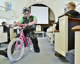 Jeff Lange | The Vindicator  SUN, MAY 22, 2016 - Dressed in full biker attire, Pastor Luke Oskin (left) cruises up the isle on his pink bicycle prior to the start of Sunday's second annual Blessing of the Bikes held at First Baptist Church of Hubbard on Sunday.