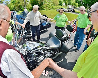 Jeff Lange | The Vindicator  SUN, MAY 22, 2016 - Members of the First Baptist Church of Hubbard gather hand-in-hand to say a prayer over Frank Rickman's motorcycle during Sunday's second annual Blessing of the Bikes in Hubbard.