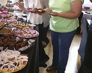 SPECIAL TO THE VINDICATOR
The Piggyback Foundation of Youngstown recently hosted a chocolate fest event at Diletto Winery in Canfield that raised over $1,700. Treats served at the event were donations from local bakeries, restaurants, candy stores and caterers. , Kaitlin, left, and Kim Casto are shown enjoying a selection of sweets. Sponsors included Anthony Bisconti Orthodontics, Styka and Ohl DDS, Valley Christian Schools and New York Life Insurance agent Albert S. Celec Jr. Funds raised during the event will benefit a 5-year-old Youngstown boy battling cancer by providing a family portrait session, backyard swing set and summer art classes for the boy’s older sibling. Making Kids Count was a partner in the event and provided the referral for the Youngstown family. The Piggyback Foundation’s mission is to support families dealing with a serious illness by providing tutoring and enrollment in extracurricular activities for children and special occasion celebrations to promote family togetherness. Volunteers are being sought for future foundation events; visit www.piggybackyoungstown.com for information. 