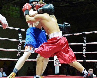 Jeff Lange | The Vindicator  WED, MAY 25, 2016 - Canfield's Georgio Poullas (red) wraps up with opponent Clinton Ewing of Howland during their super welterweight championship bout during the 2016 K.O. Drugs High School Boxing Championships at the Old South Range Gym on Wednesday.