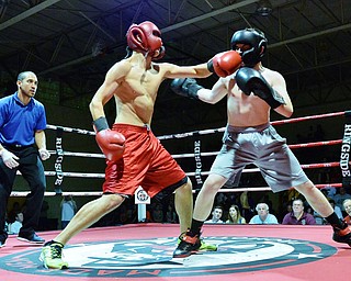 Jeff Lange | The Vindicator  WED, MAY 25, 2016 - Lakeview's Maxim McLeod (red) hits opponent Paul Smith of Greenville with a left hook during their light middleweight bout during the 2016 K.O. Drugs High School Boxing Championships at the Old South Range Gym on Wednesday.