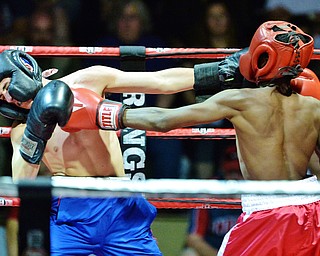 Jeff Lange | The Vindicator  WED, MAY 25, 2016 - Labrae's Brandon Woolard (left) and Sharon's Calvin Davis exchange jabs during their super featherweight bout during the 2016 K.O. Drugs High School Boxing Championships at the Old South Range Gym on Wednesday.