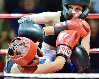 Jeff Lange | The Vindicator  WED, MAY 25, 2016 - Lakeview's Madison Meeker (blue) pounds opponent Anastasia McLeod of Lakeview with a right hook during their girls lightweight bout during the 2016 K.O. Drugs High School Boxing Championships at the Old South Range Gym on Wednesday.