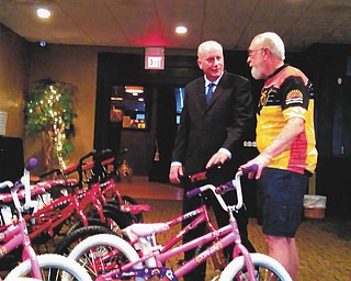 SPECIAL TO THE VINDICATOR
Out-Spokin’ Wheelmen recreational bicycling club recently donated a dozen boys and girls bicycles to benefit the Youngstown United Way. Bob Hannon, left, United Way director, is shown speaking with John Thomas, OSW member, about the collection of bicycles that were supplied by Frankford Bicycles in Girard that will benefit the children that complete the United Way’s Success After Six program.