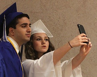 Nikos Frazier | The Youngstown Vindicator..Courtney Jennings(right) and Mo Rasoul(left) pose for a selfie before the Hubbard High School graduation at Stambaugh Auditorium.