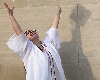 Nikos Frazier | The Youngstown Vindicator..Emma Kanning throws her cap into the air outside of Stambaugh auditorium after graduating from Hubbard High School.
