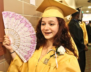 William d Lewis the vindicator HArding grad Jaclyn Ruiter uses a fan to stay cool while waiting for commencement to start 5-26-16 at PAckard Music Hall in Warren.
