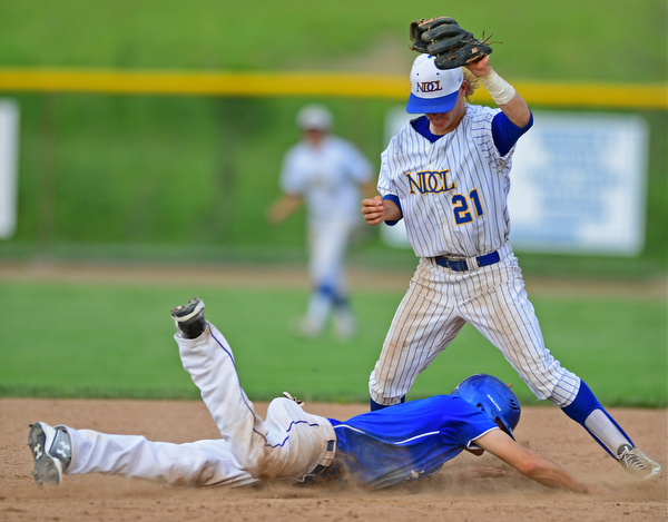 HUDSON, OHIO - MAY 26, 2016: Jared Burkert #6 of Poland dives back into second base avoiding a pickoff attempt from second basemen Sam Frontine #21 of NDCL in the fourth inning of Thursday afternoons Division 2 Regional Semi-Final game at the Ballpark at Hudson. Poland won 8-2. DAVID DERMER | THE VINDICATOR