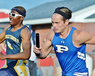 Jeff Lange | The Vindicator  THU, MAY 26, 2016 - Poland's Tyler Smith (right) participates against a Streetsboro runner in the boys 4x200 meter relay race during Thursday's Division II regional track meet at Austintown Fitch High School.
