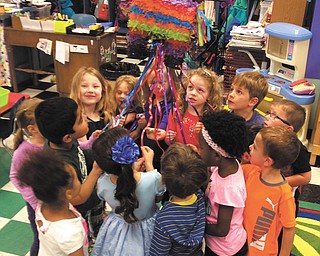 SPECIAL TO THE VINDICATOR
Children in Barbara Conti’s preschool enrichment class at Ursuline Preschool and Kindergarten celebrated Cinco de Mayo recently by participating in some of the traditions of the holiday. Above, the children take part in breaking a piñata. The also made maracas and did a Mexican hat dance.