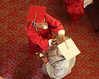  Nikos Frazier | The Youngstown Vindicator..Two Chaney Campus High School senior help each other with their caps before lining up to walk across the stage and receive their diplomas.