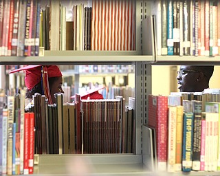  Nikos Frazier | The Youngstown Vindicator..LaRazia Tolbert(left) talks with Marckese Williams(right) in the school library before the 2016 Chaney Campus High School Commencement on Friday, May 27, 2016.