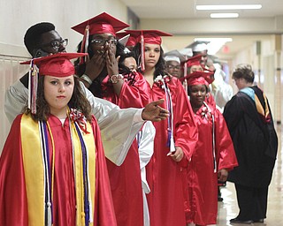  Nikos Frazier | The Youngstown Vindicator..Taylor Acierno(front) waits in the hallway of Chaney Campus High School before walking into the auditorium with her senior class to receive their diplomas.