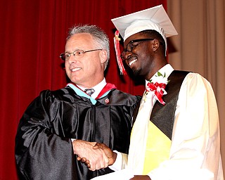  Nikos Frazier | The Youngstown Vindicator..Principal Joseph Krumpak(left) shakes Marckese Williams(right) hand after Williams received his diploma from Chaney Campus High School.