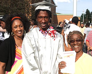  Nikos Frazier | The Youngstown Vindicator..(left to right) Lawanda Mims, Dayshawn Mims, and Theressa Mims pose for a photo outside Chaney Campus High School after Dayshawn received his diploma.