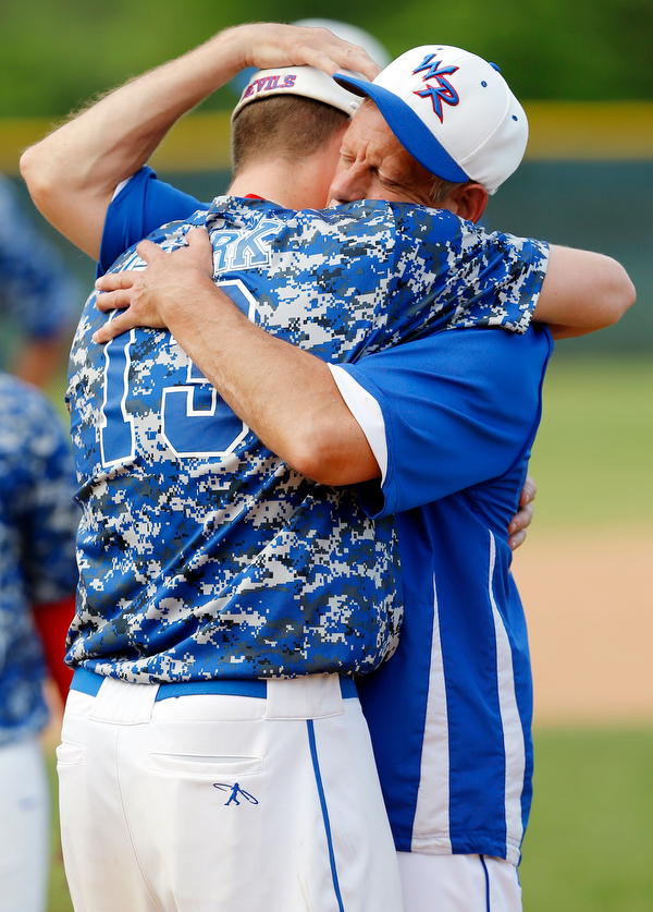 052716 - Western Reserve's senior Jake Clark (13) and head coach Ed Anthony share a hug after their loss to Cuyahoga Heights Redskins 6-5.