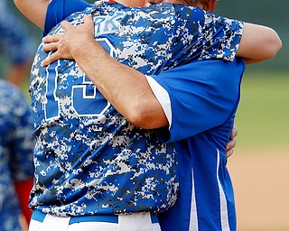 052716 - Western Reserve's senior Jake Clark (13) and head coach Ed Anthony share a hug after their loss to Cuyahoga Heights Redskins 6-5.