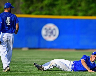 HUDSON, OHIO - MAY27, 2016: Left fielder Tony Chaire #20 of Poland falls on the ground after making a diving catch in the fifth inning of Friday afternoons Division Two Regional Final at the Ballpark at Hudson. Poland won 13-3. DAVID DERMER | THE VINDICATOR..Teammate Anthony Calcagni #4 of Poland pictured.